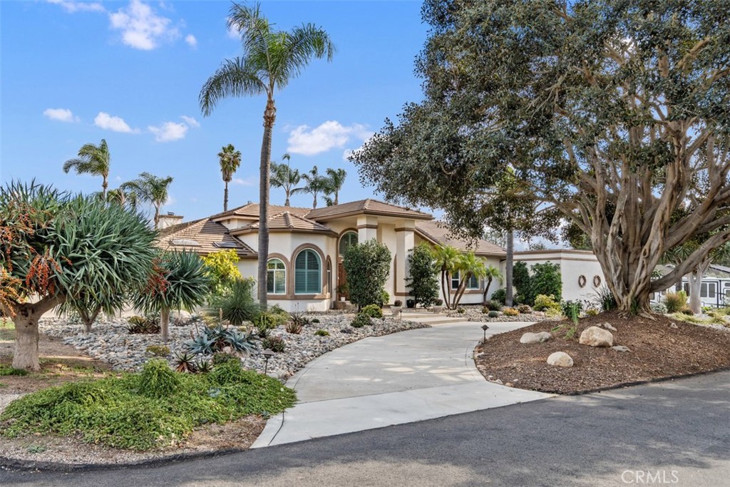 3950 Concordia Lane Fallbrook, CA 92028 - Photo 47 of 51 a view of a building with a yard and potted plants