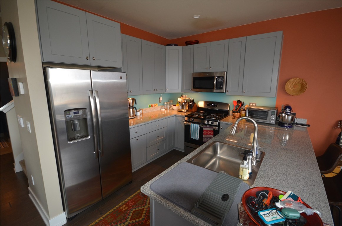 13 Haymaker Street Silverthorne, CO 80498 - Photo 5 of 21 a kitchen with stainless steel appliances a refrigerator a sink a stove a microwave and wooden cabinets