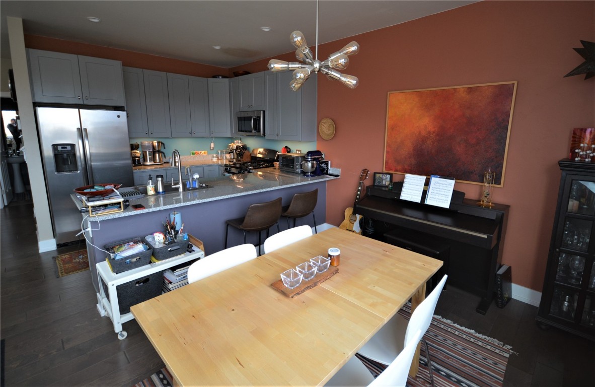 13 Haymaker Street Silverthorne, CO 80498 - Photo 6 of 21 a kitchen with a table chairs stove and refrigerator