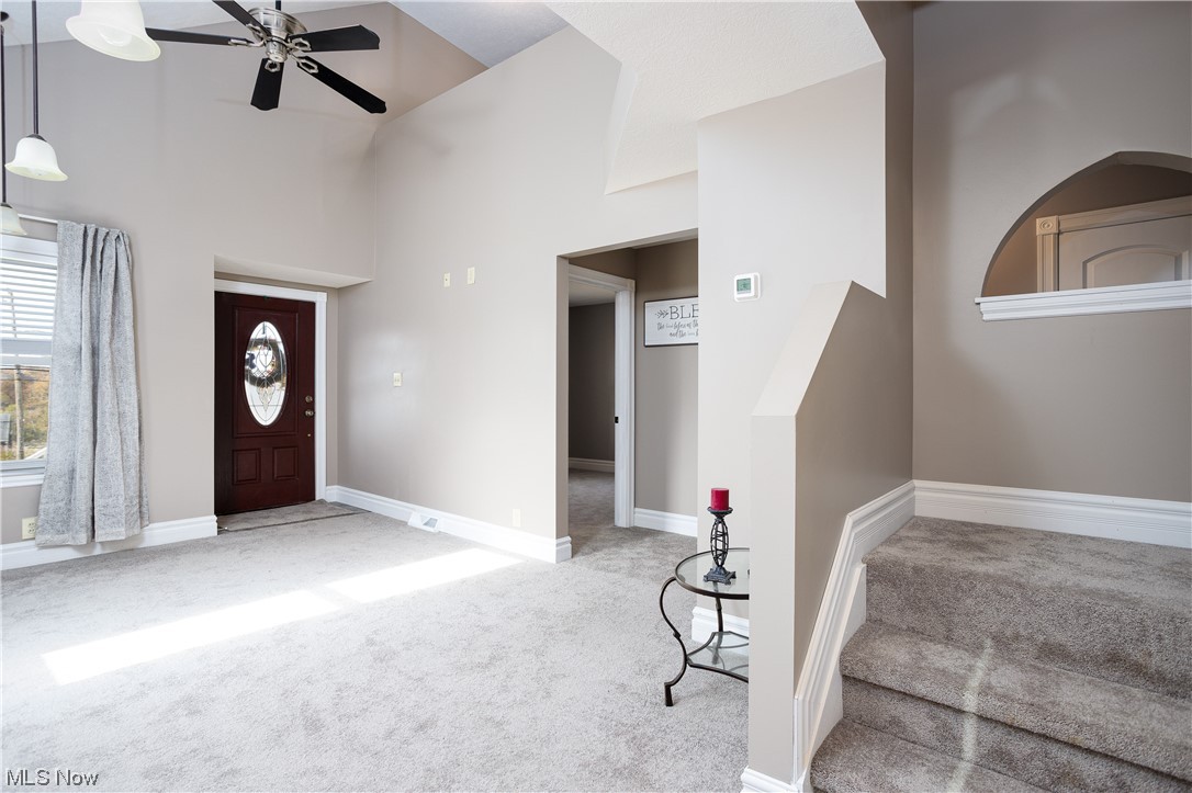 8409 Wadsworth Road Wadsworth, OH 44281 - Photo 11 of 23 Entrance foyer featuring light colored carpet, high vaulted ceiling, and ceiling fan