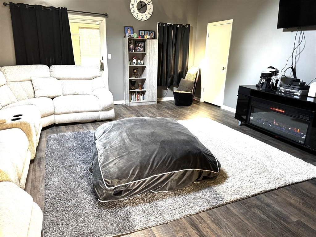 36 Rowley Road Topsfield, MA 01983 - Photo 8 of 29 a bedroom with a bed and wooden floor
