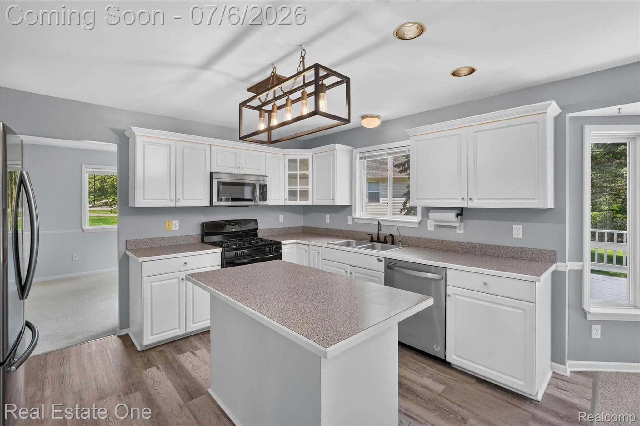 9610 Forest Ridge Drive Clarkston, MI 48348 - Photo 14 of 77 Bathed in natural light, this bright and airy kitchen features crisp white cabinetry, stainless steel appliances, and a spacious center island with seating, making it the perfect hub for everyday living and entertaining. Updated designer lighting adds a modern touch, while generous counter space, abundant storage, and an open layout create both beauty and functionality. Seamlessly connected to the family room and overlooking the backyard, this inviting kitchen is truly the heart of the home.