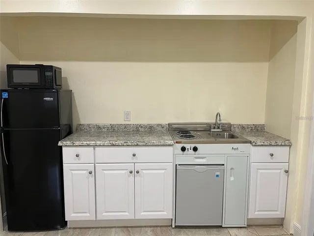 a stove top oven sitting inside of a kitchen