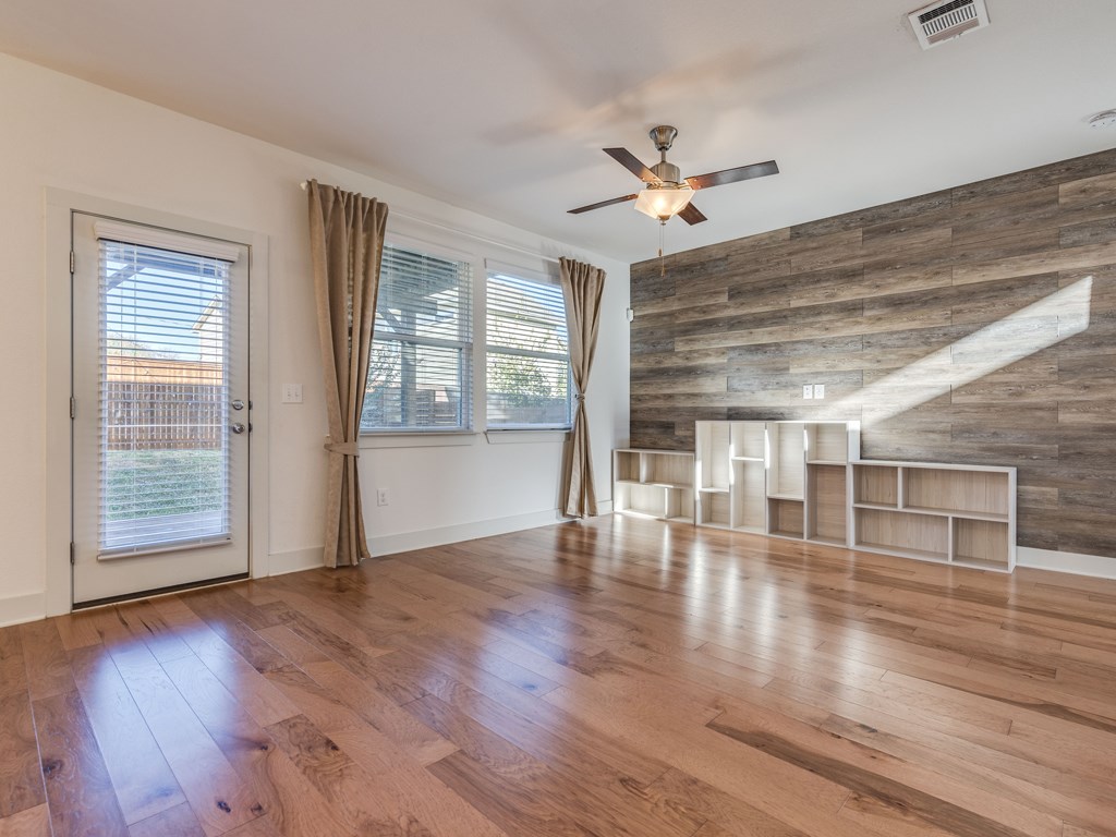 2208 Capulet Street Austin, TX 78741 - Photo 6 of 23 a view of empty room with wooden floor and fan