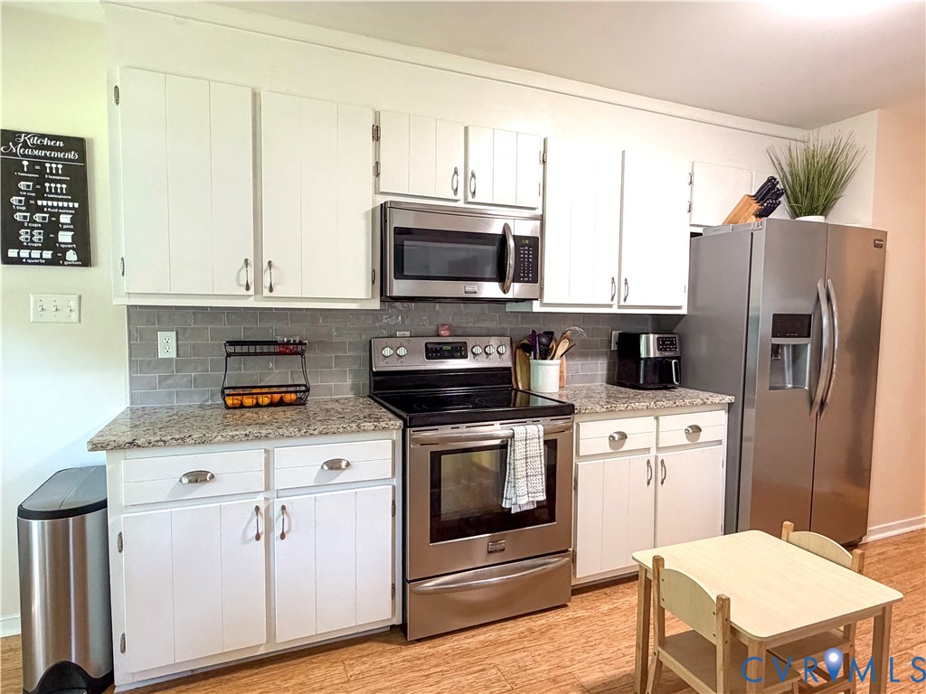 4924 Wilconna Road Chesterfield, VA 23832 - Photo 7 of 22 Kitchen featuring white cabinetry, gray subway til