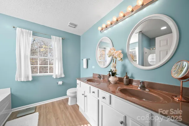 a bathroom with a double vanity sink and a mirror