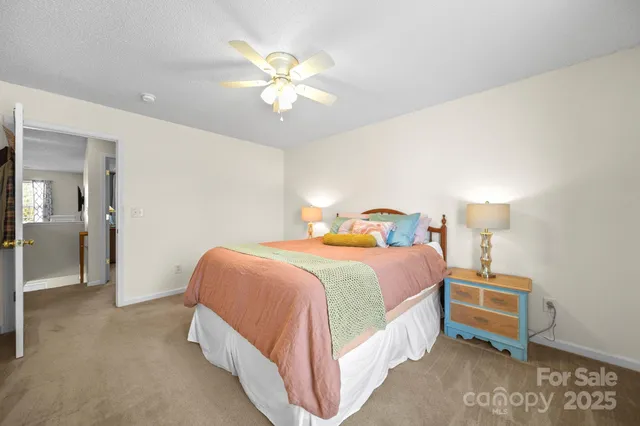 a spacious bedroom with a bed and a chandelier