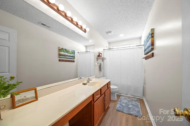 a spacious bathroom with a sink and a mirror