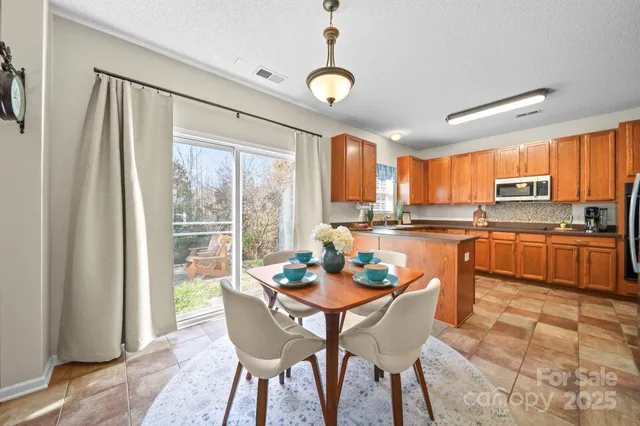 a kitchen with a table chairs and microwave