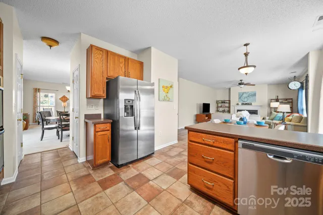 a kitchen with stainless steel appliances granite countertop a refrigerator and a sink