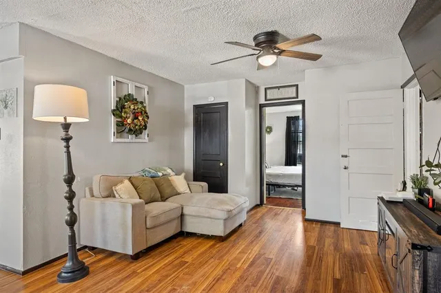 a living room with furniture and a wooden floor