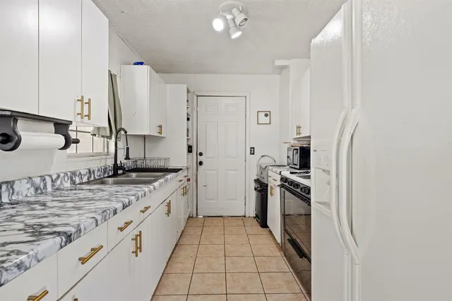 a kitchen with stainless steel appliances granite countertop a sink and a stove