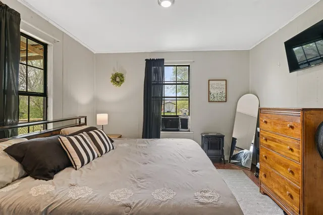 a bedroom with a bed and a television