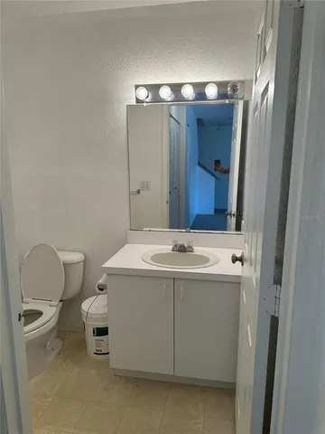 a bathroom with a sink vanity and toilet