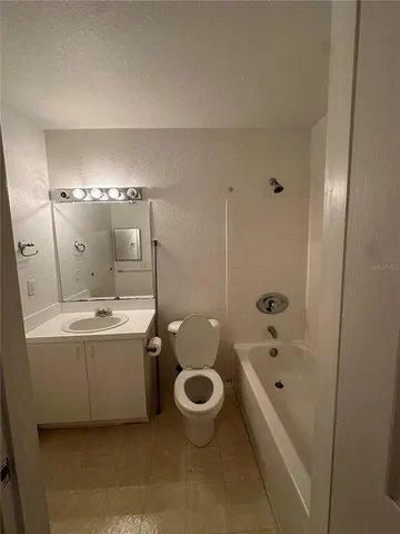 a bathroom with a tub a sink and mirror