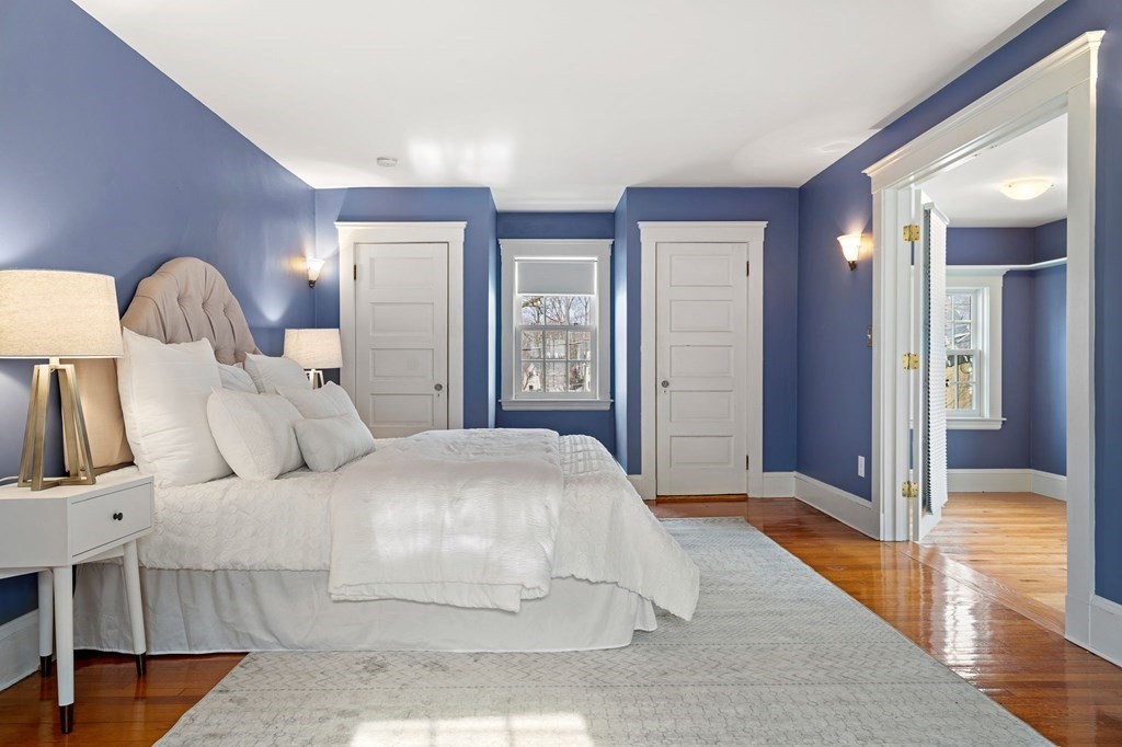 22 Ardmore Road Newton, MA 02465 - Photo 9 of 18 a bedroom with a large bed and a chandelier