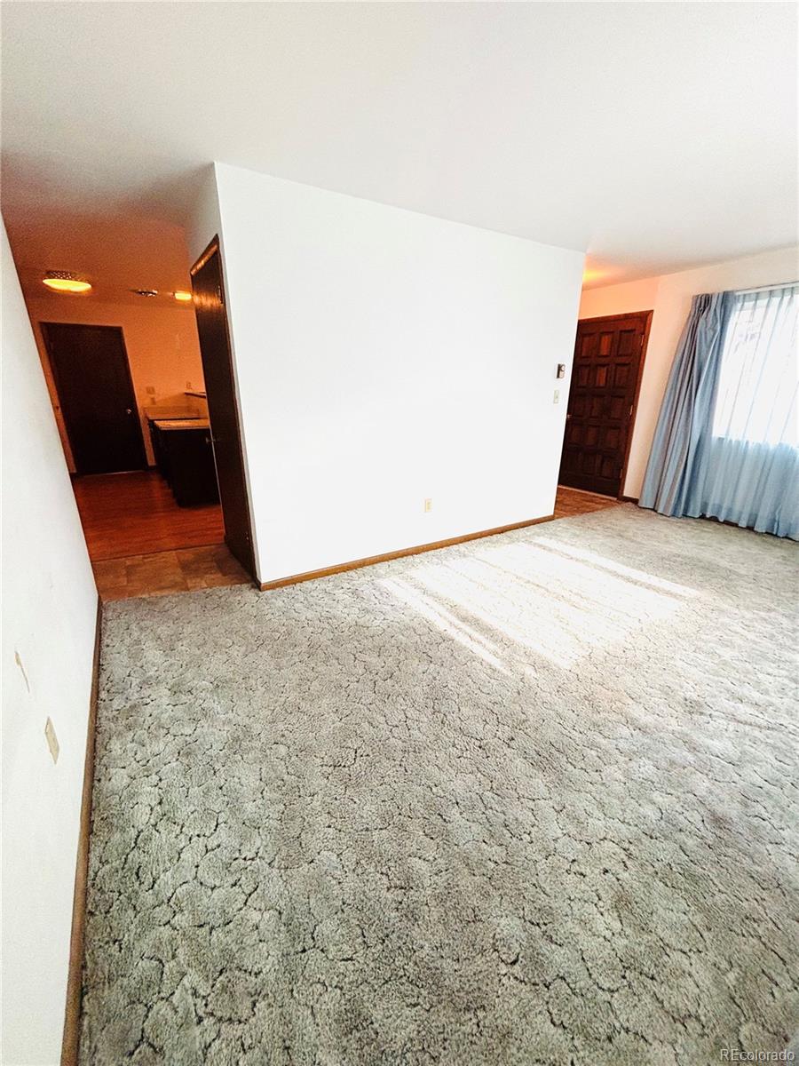 503 Elm Street Fort Morgan, CO 80701 - Photo 11 of 26 a view of an empty room and wooden floor