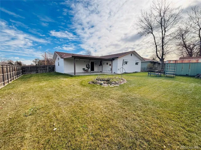 a view of a house with a yard and sitting area