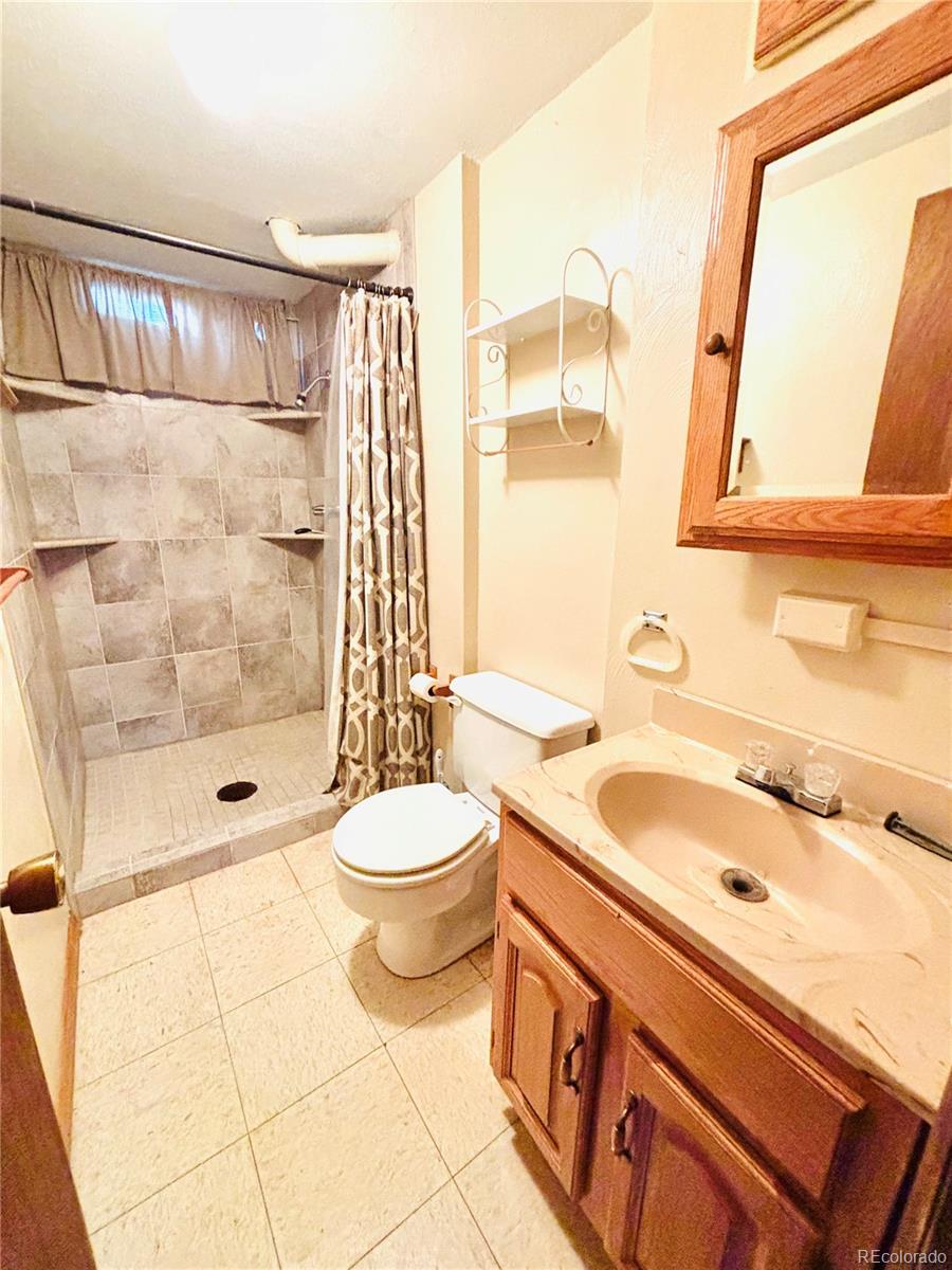 503 Elm Street Fort Morgan, CO 80701 - Photo 22 of 26 a bathroom with a sink a toilet and shower