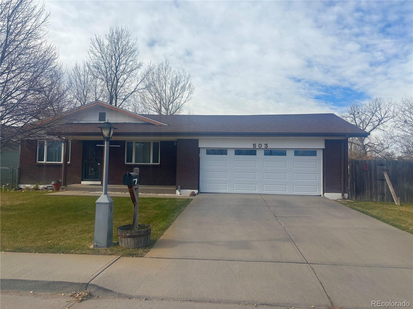 503 Elm Street Fort Morgan, CO 80701 - Photo 3 of 26 front view of a house with a yard