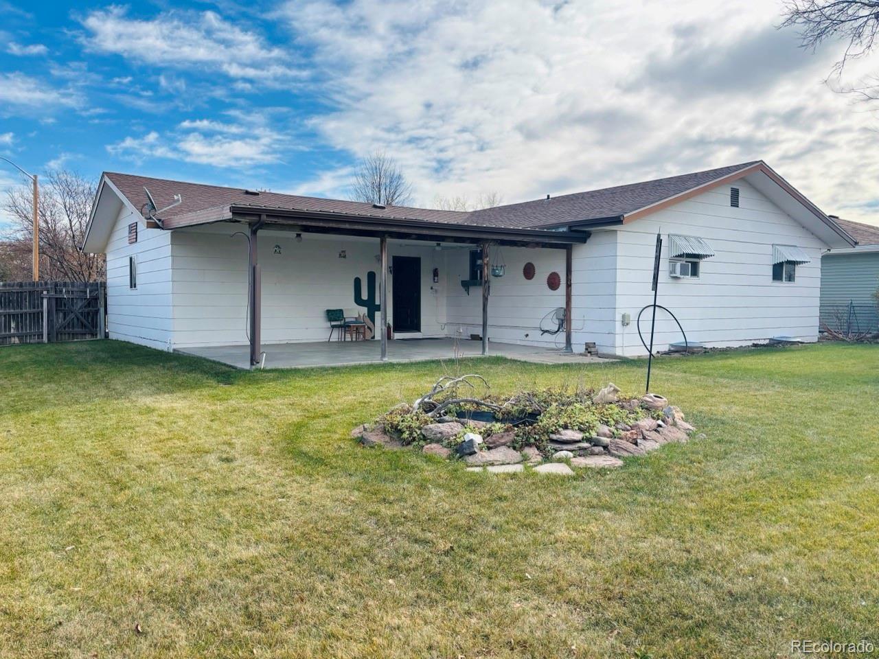503 Elm Street Fort Morgan, CO 80701 - Photo 4 of 26 a view of a house with a yard