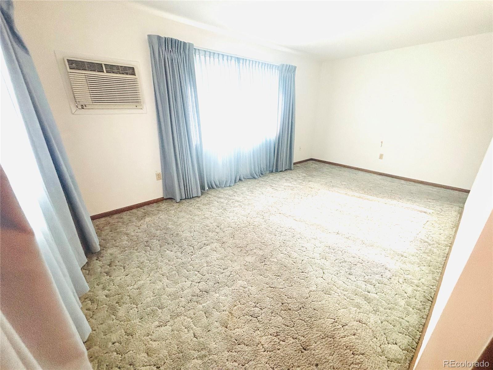 503 Elm Street Fort Morgan, CO 80701 - Photo 9 of 26 a view of empty room with wooden floor