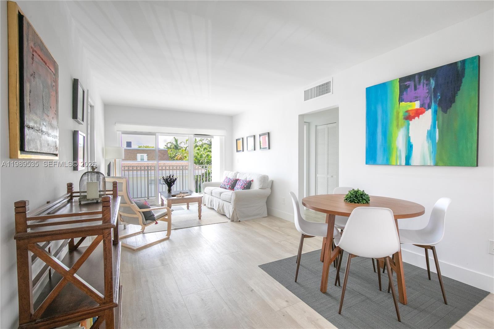 a living room with furniture a rug and a painting on the wall