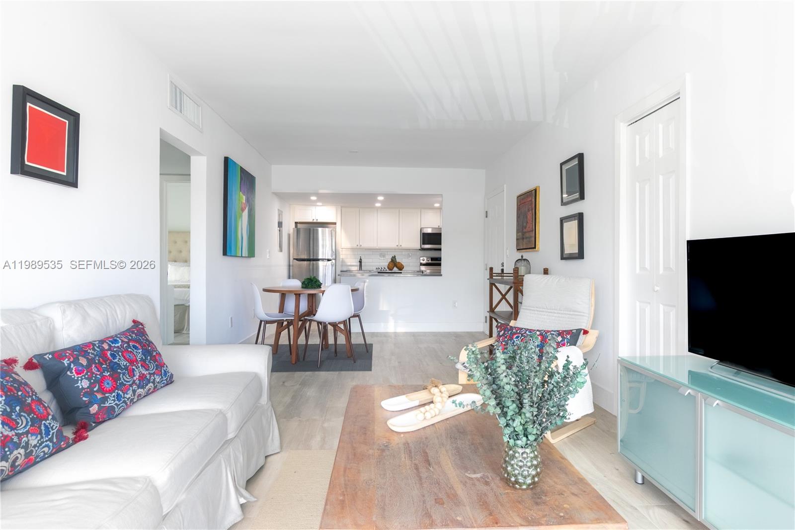 290 Sunrise Drive, Unit 3F Key Biscayne, FL 33149 - Photo 11 of 19 a living room with furniture and a flat screen tv
