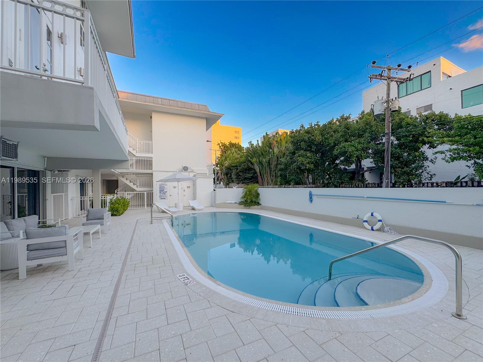 290 Sunrise Drive, Unit 3F Key Biscayne, FL 33149 - Photo 15 of 19 a view of a swimming pool with a patio