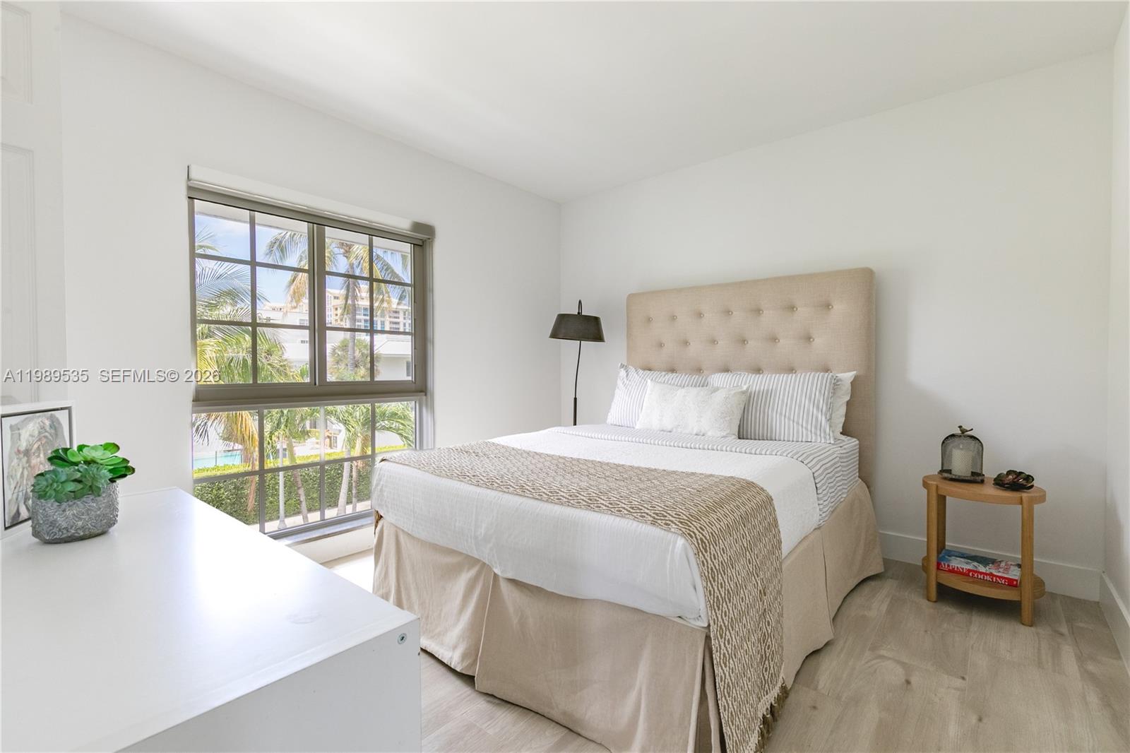 290 Sunrise Drive, Unit 3F Key Biscayne, FL 33149 - Photo 2 of 19 a bedroom with a bed and a large window