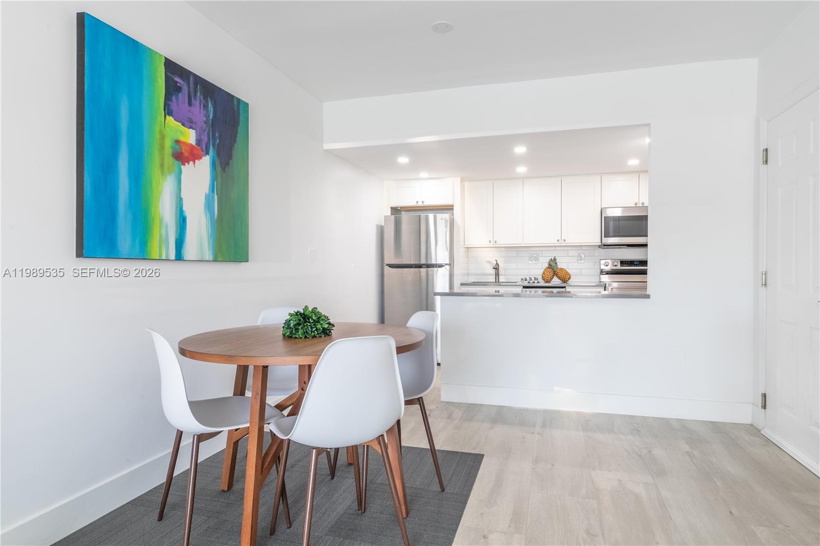 290 Sunrise Drive, Unit 3F Key Biscayne, FL 33149 - Photo 4 of 19 a view of kitchen with furniture and wooden floor