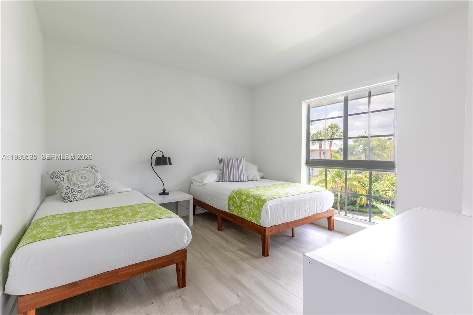 290 Sunrise Drive, Unit 3F Key Biscayne, FL 33149 - Photo 6 of 19 a bedroom with two beds and next to a window