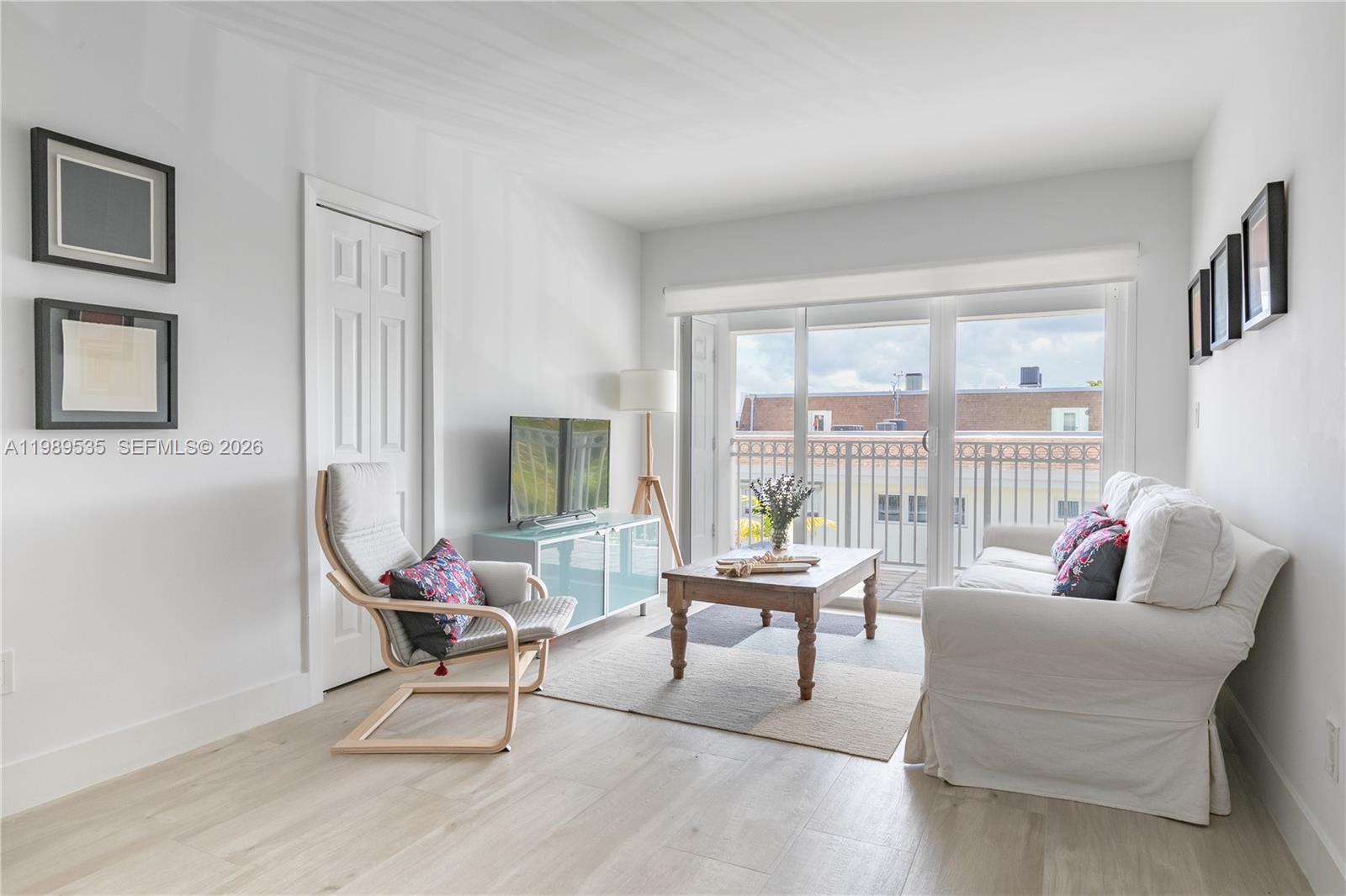 290 Sunrise Drive, Unit 3F Key Biscayne, FL 33149 - Photo 9 of 19 a living room with furniture and a large window