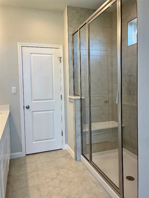 320 Creek Road, Unit 203 Dripping Springs, TX 78620 - Photo 7 of 14 a bathroom with a glass shower door