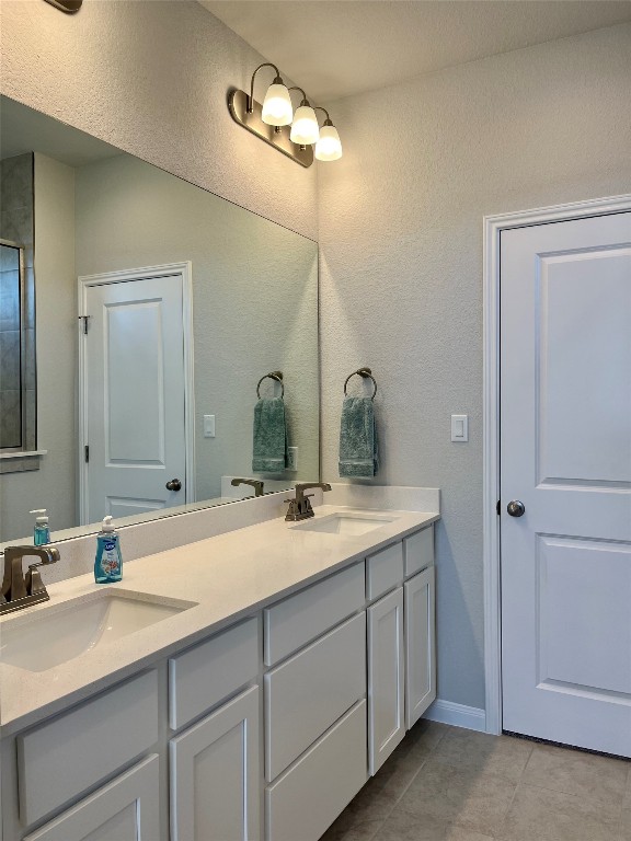 320 Creek Road, Unit 203 Dripping Springs, TX 78620 - Photo 8 of 14 a bathroom with a double vanity sink and a mirror