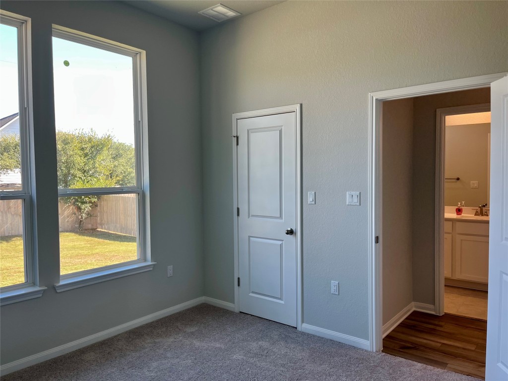 320 Creek Road, Unit 203 Dripping Springs, TX 78620 - Photo 9 of 14 an empty room with windows and closet