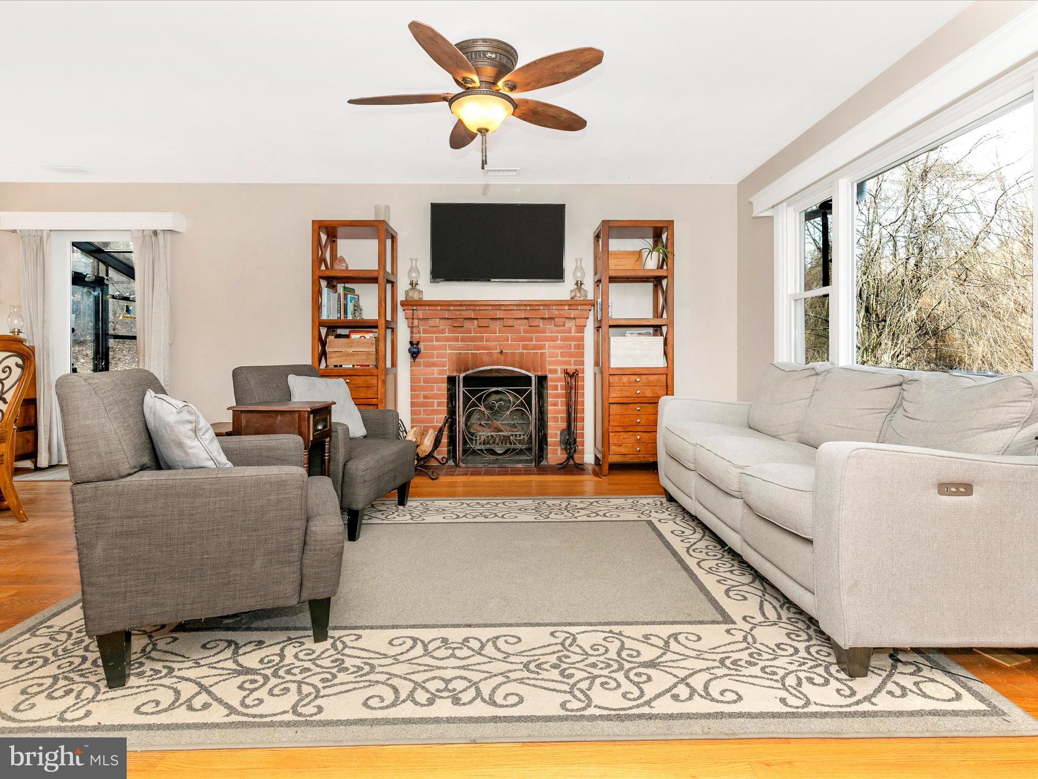8321 Edgewood Church Road Frederick, MD 21702 - Photo 3 of 73 a living room with furniture a rug and a fireplace