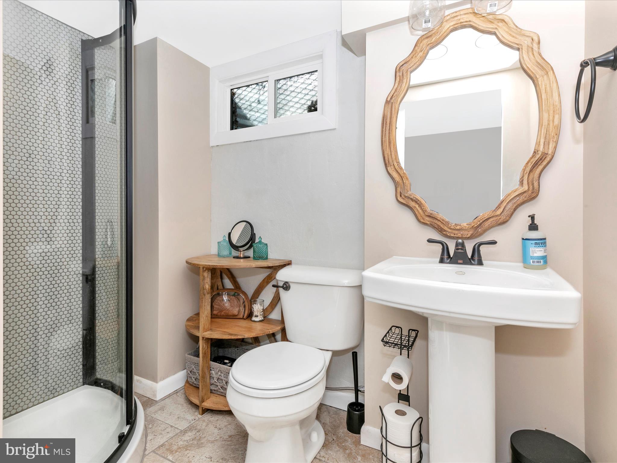 8321 Edgewood Church Road Frederick, MD 21702 - Photo 46 of 73 a bathroom with a toilet a sink and a mirror