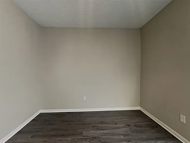 a view of an empty room and wooden floor