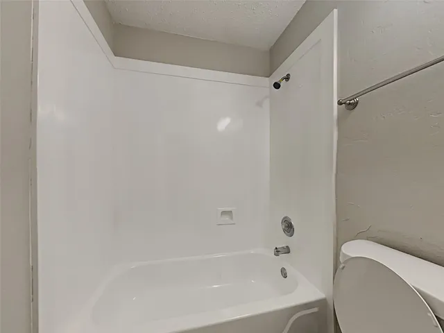 a bathroom with a bathtub and a toilet