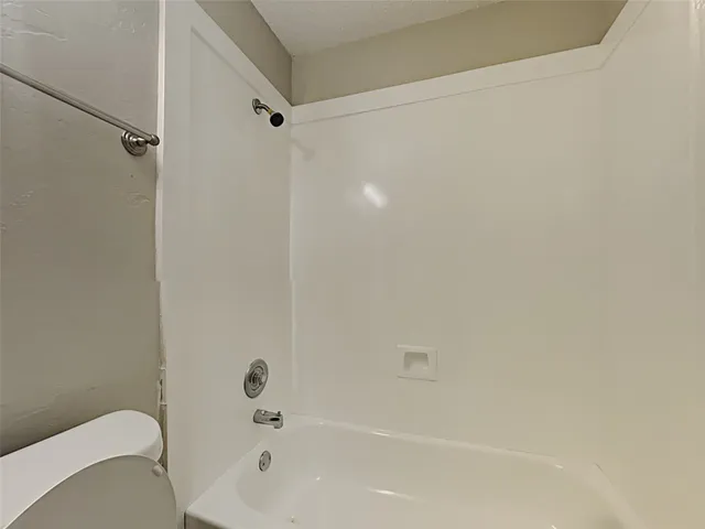 a bathroom with a bathtub and a toilet