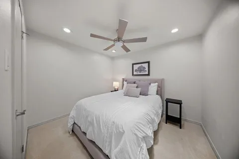 a spacious bathroom with a granite countertop sink a toilet and shower