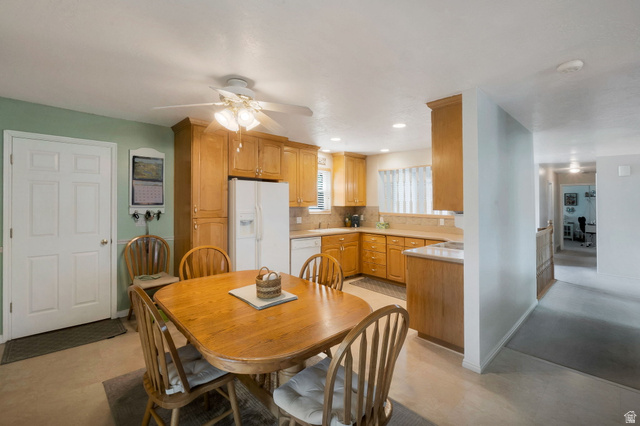11072 Windy Peak Ridge Drive, Unit 32 Sandy, UT 84094 - Photo 7 of 30 Kitchen with wood-finish cabinetry, solid surface countertops, and integrated appliances