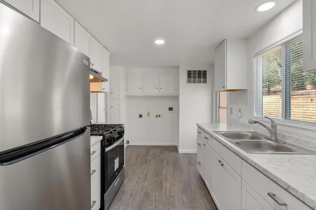 a kitchen that has a sink and a stove