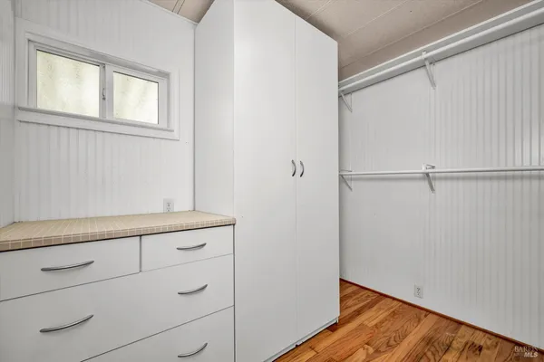a view of storage and utility room with wooden floor