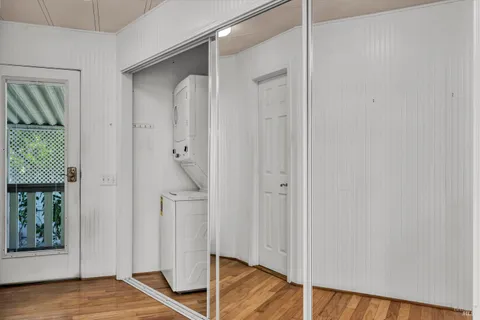 a view of empty room with wooden floor and windows