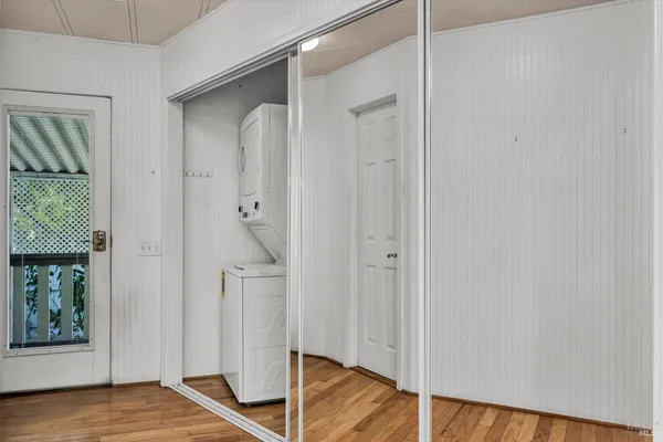 a view of empty room with wooden floor and windows