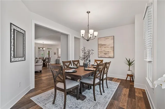 a kitchen with stainless steel appliances granite countertop a sink a stove a refrigerator and island