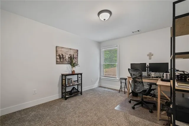 a spacious bedroom with a bed and a chandelier