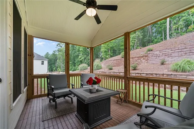 a living room with patio furniture and a floor to ceiling window